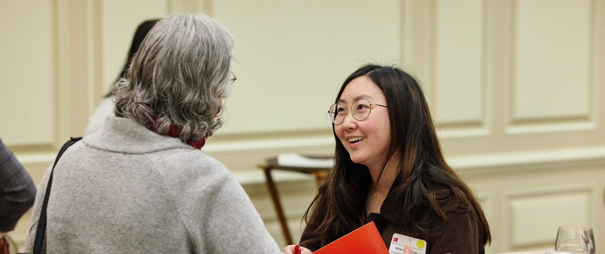 Student speaks with faculty member at accepted student day