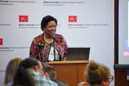 Shows Leah Hollis speaking at the alumni awards ceremony