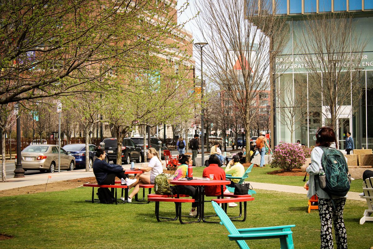 Students sitting on picnic benches