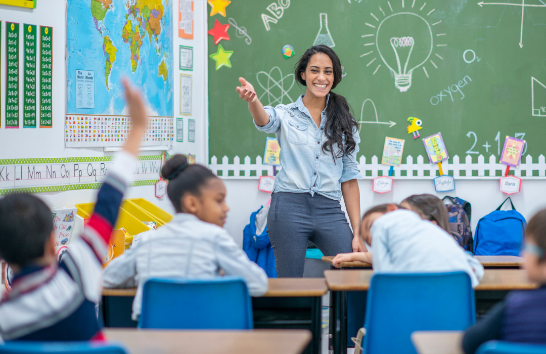 Young female teacher in elementary classroom teaching science