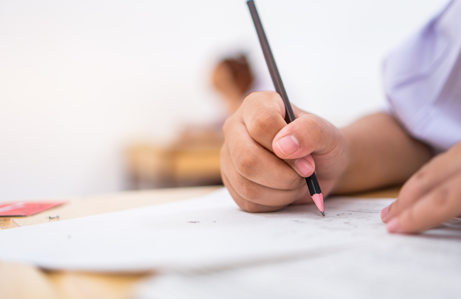 hands of a young student writing