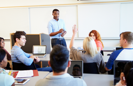 male teacher talking to classroom of students