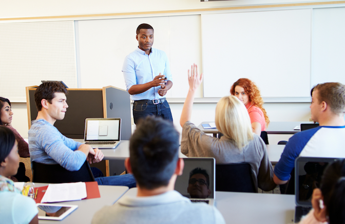 male teacher talking to classroom of students