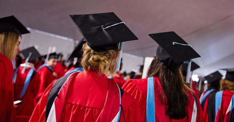 the back of students in their cap and gowns