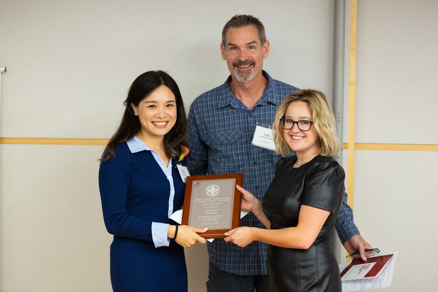 Karen Lo with John McCarthy and Addie LaRoche holding award plaque 