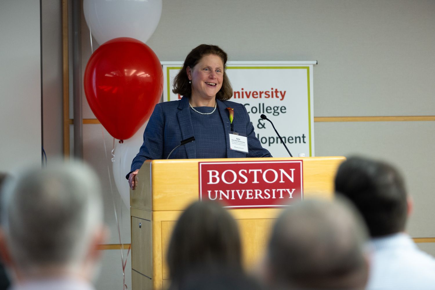 Kyla McSweeney (94,’97) speaking at podium accepting her 2023 Alumni Awards