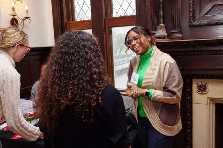 faculty member Davena Jackson speaking with a prospective student at accepted students day