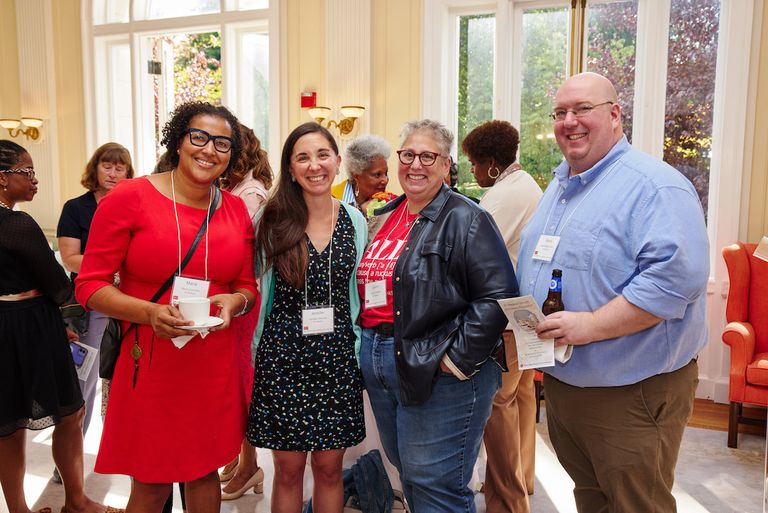 faculty smiling at camera during Lucy Wheelock Tea