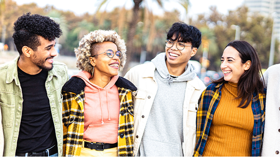 Shows five young adults walking together