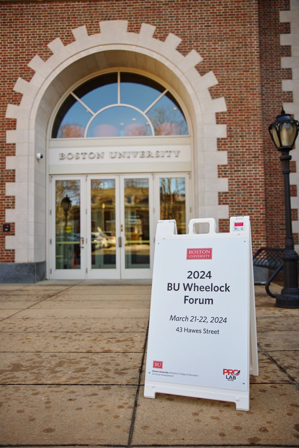 sign reading 2024 BU Wheelock Forum outside of the Hawes Building
