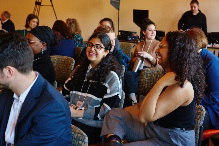 A group of students talking with each other and networking
