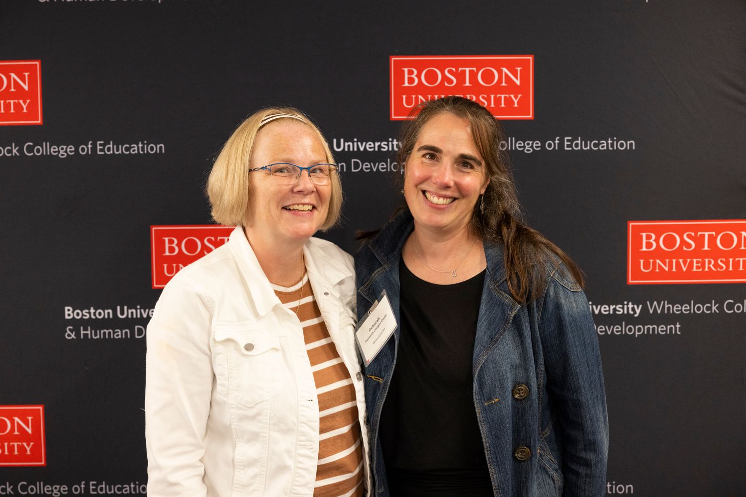 Two Wheelock Alums smiling at camera