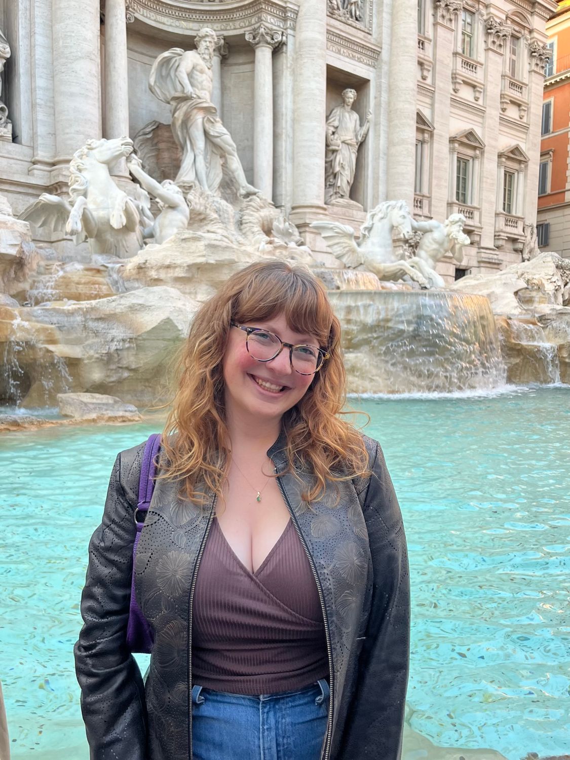 Renata Feinstein standing and smiling outside of the trevi fountaint