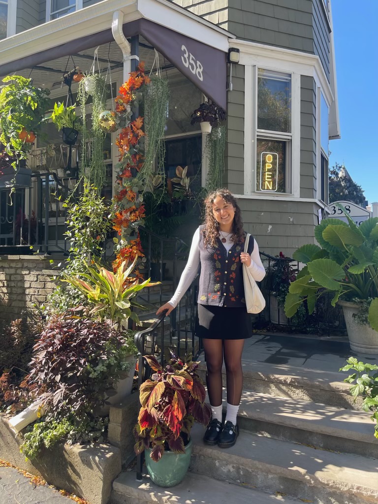 Gracy Szewc smiling outside around plants outside a building