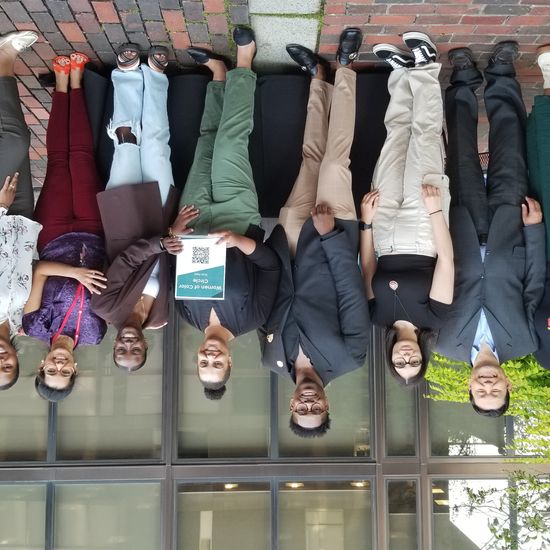 Group of 11 posing for photo outside at the GSU Plaza.