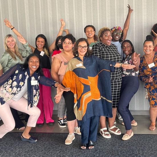 Group of joyful women in group photo poses.