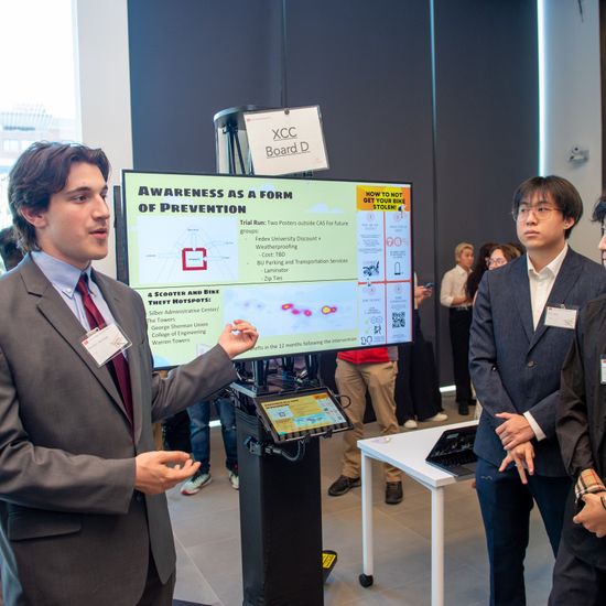 Four students are presenting their project at an expo.